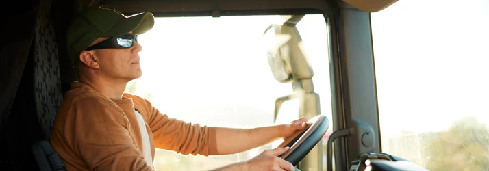 Chiropractic Indiana PA DOT Truck Driver A truck driver wearing sunglasses monitors the road while driving